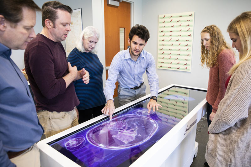 Students examining a touchscreen computer